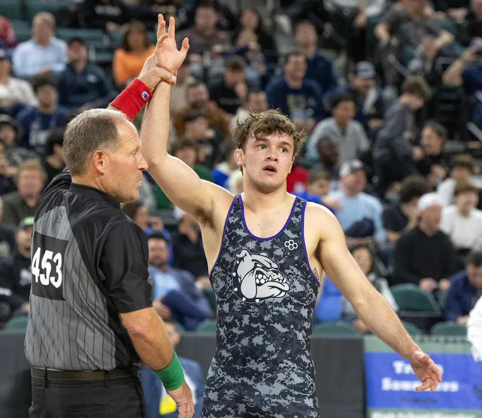 Rumson-Fair Haven's Sonny Amato gets his hand raised by referee Ed Tonnessen after he won the 150-pound state championship Saturday.