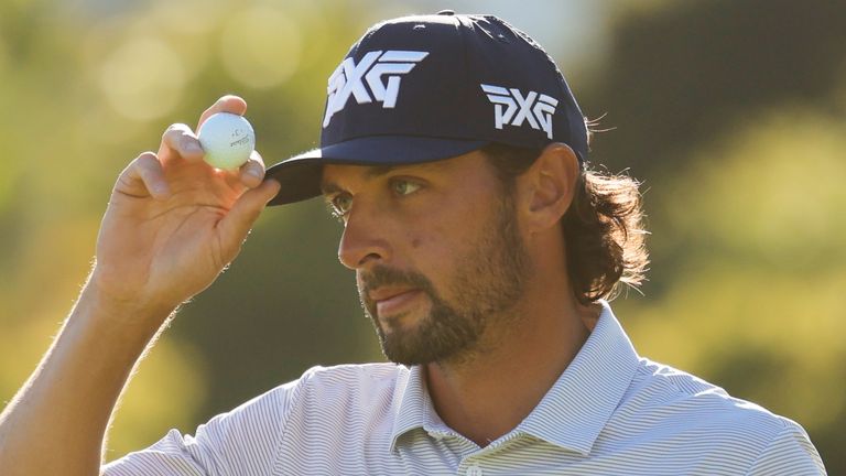 Marco Penge, from England, tips his hat after finishing on the 18th green during the third round of the Genesis Invitational golf tournament