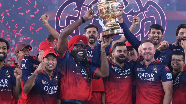 Royal Challengers Bengaluru's Virat Kohli, center, flanked with former teammates Chris Gayle, in red turban, and AB de Villiers after their win in the Indian Premier League final cricket match against Punjab Kings at Narendra Modi Stadium in Ahmedabad, India, Wednesday, June 4, 2025. (AP Photo/Ajit Solanki)